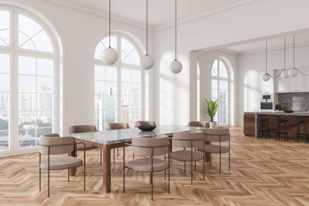 istock Modern kitchen and dining room with large windows, natural light, and a spacious layout featuring wood floors and clean, contemporary design. 3D Rendering 2191175623