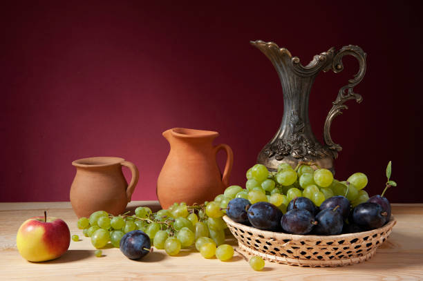 istock Still life, metal jug, ceramic dishes, apple and grapes 2191176452