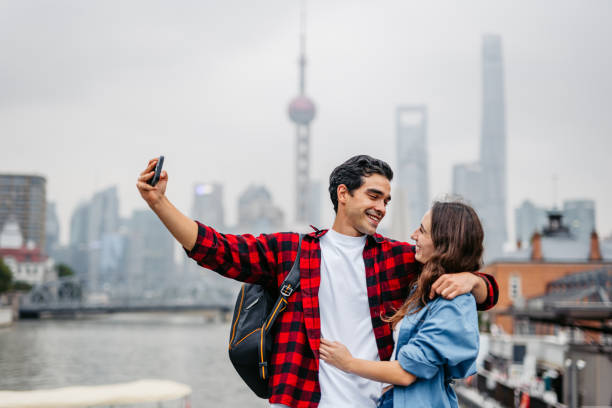 istock Young Couple Taking Selfies Using Phone On The Bridge In Shanghai In China 2191179082