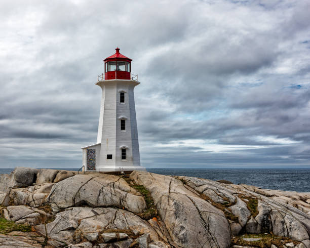 istock Lighthouse on Rocky Coast with Ocean Background 2191180833