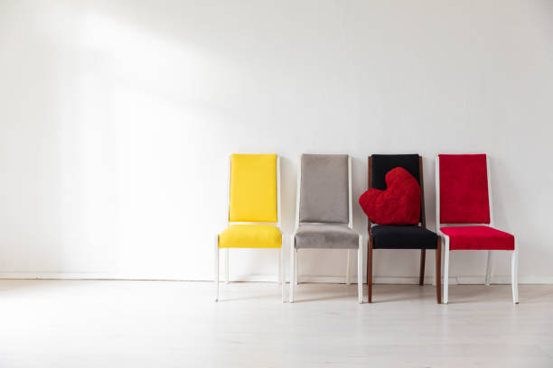 Four chairs in the interior of an empty white room