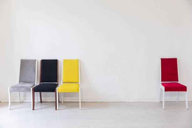 Four chairs in the interior of an empty white room