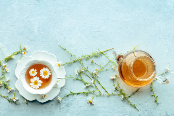 istock Chamomile flower tea. A tea cup and a tea pot with fresh medicinal flowers 2191182348