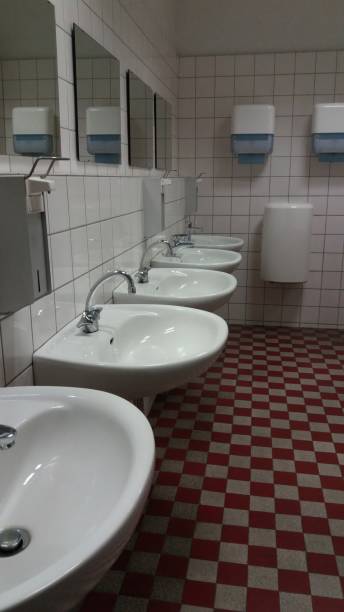istock Contemporary and Modern Restroom Featuring Stylish Sinks and Elegant Mirrors for Everyone 2191183215