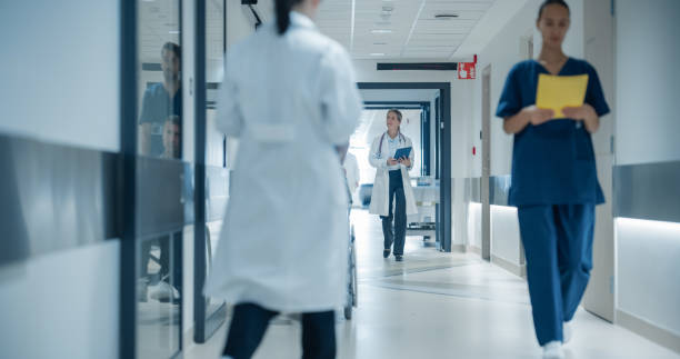 istock Portrait of a Female General Practitioner Using Tablet Computer to as She is Walking and Browsing Insights About a Complex Case. Healthcare Workers Walking Through a Modern Hospital Corridor 2191184038