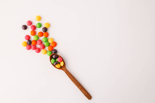 istock Chocolate round candies scattered on white isolated background 2191184397