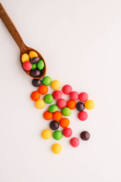 istock Chocolate round candies scattered on white isolated background 2191184400