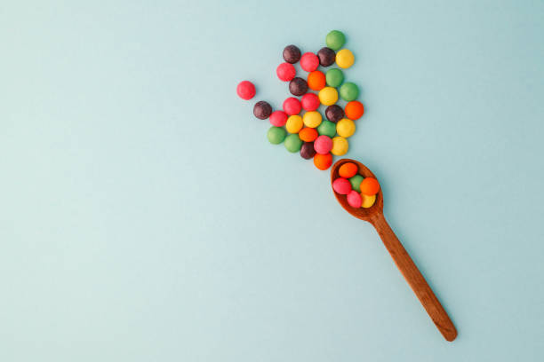 istock Chocolate round candies scattered on a soft blue background 2191184410