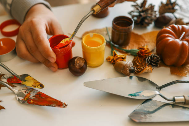 istock Creative autumn art activity with paint and natural materials like pine cones, acorns, and chestnuts, crafting seasonal decorations 2191184923