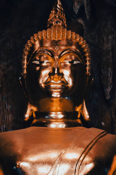 istock Buddha statue in the cave with tree in the background. 2191185829