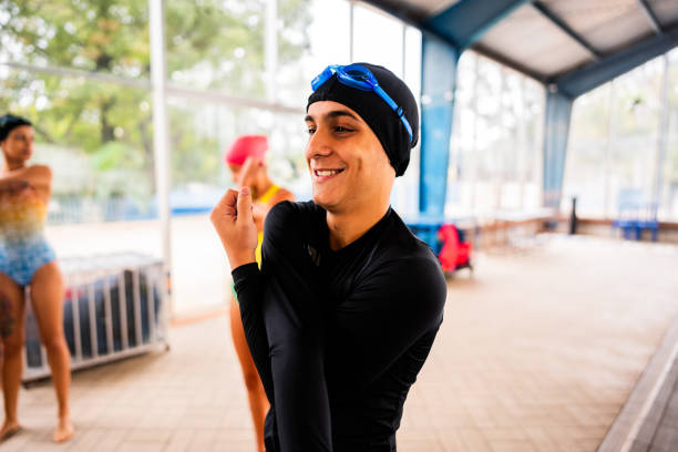 Teenager boy stretching in swimming class