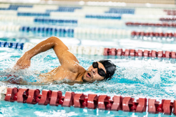 Young man swimming in the swimming pool