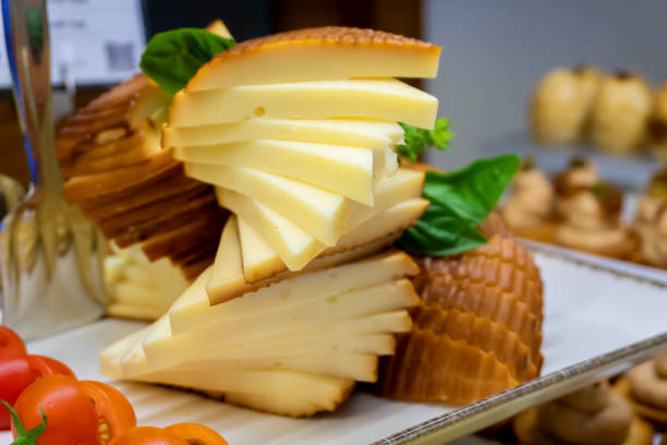istock Slices of processed cheese with tomatoes on a tray - Close-up 2191188168
