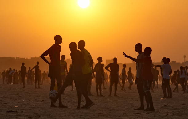 Dakar. Senegal. October 13, 2021. Residents of the capital are massively playing beach soccer on the west coast of Africa at sunset on a sultry day.