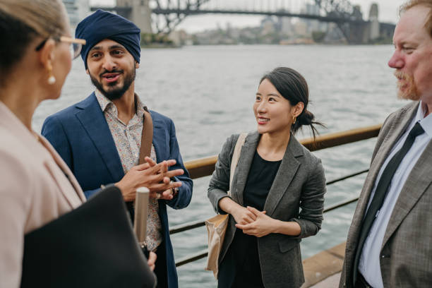 istock Colleagues conversing on a waterfront cityscape 2191192515