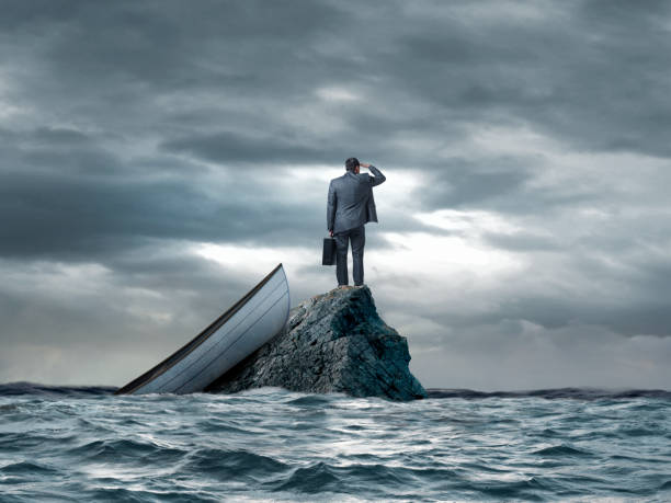 istock Man Stranded In On Small Rock In The Ocean 2191192636