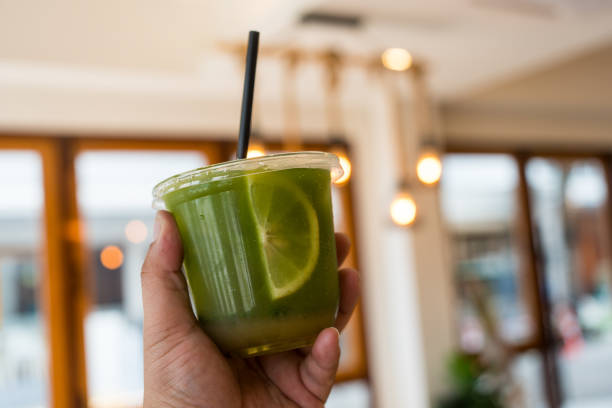 istock Delicious lemon green tea drinks in plastic cup on hand. 2191193102