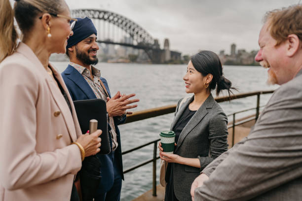istock Engaged professionals by harbor with famous bridge 2191193740