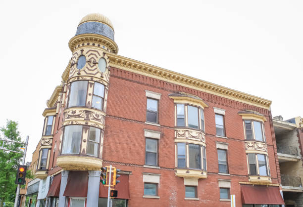 A Victorian-era building with a yellow turret on the corner in Janesville, Wisconsin