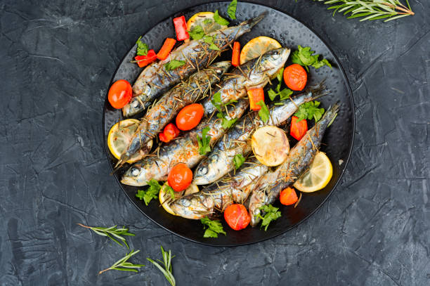 istock Grilled sardines on a plate with lemon. 2191195605