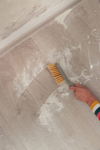 istock Woman sweeping the floor after renovation 2191198455