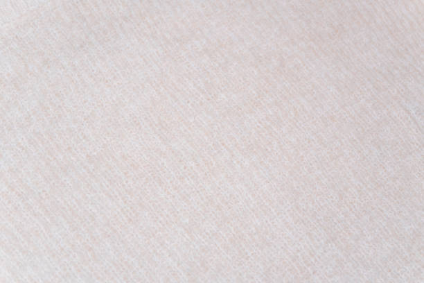 istock Uniform beige texture: A flat surface of beige wool fabric with no visible knit pattern. 2191202096