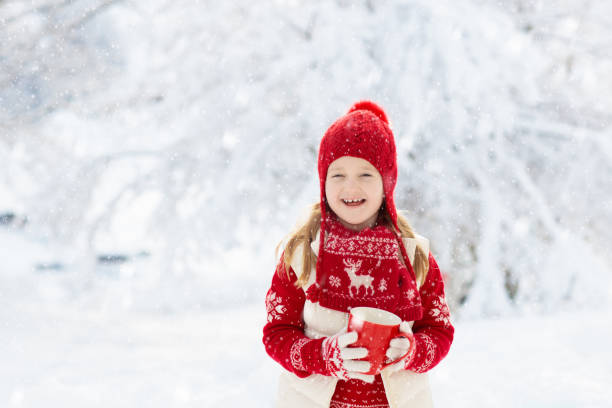 istock Child drinking chocolate on Christmas in snow 2191202500
