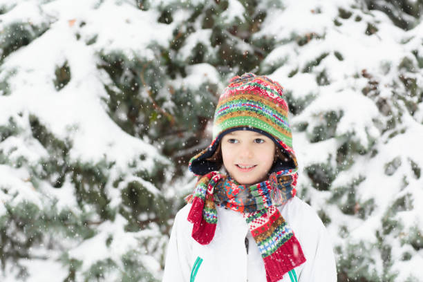 istock Kids play in snow in winter park 2191202720