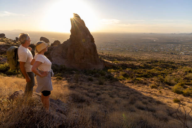 istock Mature couple hike below rock spire at sunset 2191202871