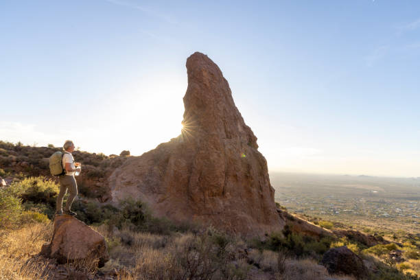 istock Mature man backpacker pauses on rock below pinnacle 2191202872