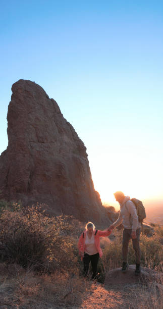 istock Mature couple hike below rock spire at sunset 2191202919