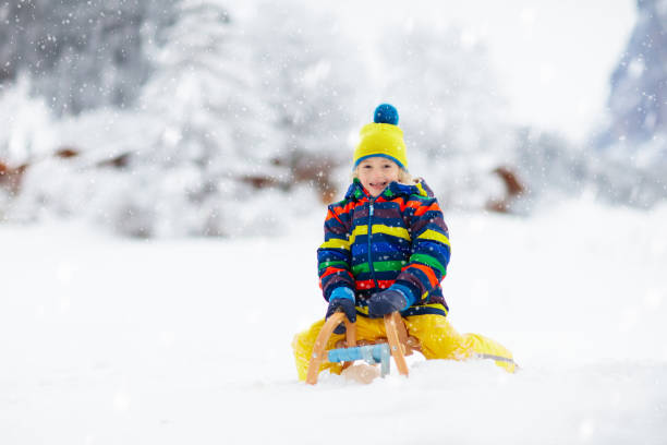 istock Boy on sled ride. Child sledding. Kid on sledge 2191203033