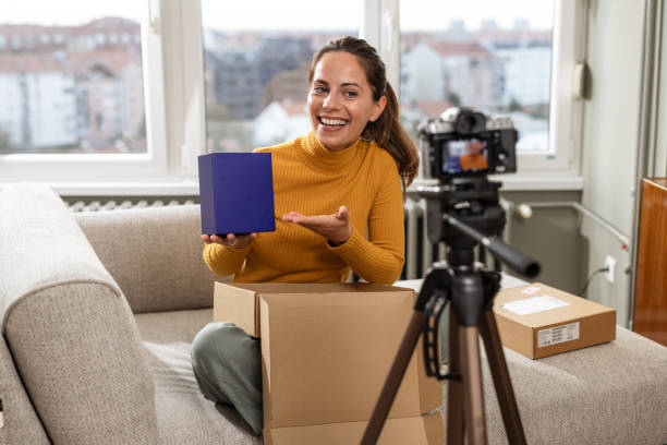 istock A cheerful woman vlogging about e-commerce products at home 2191203055
