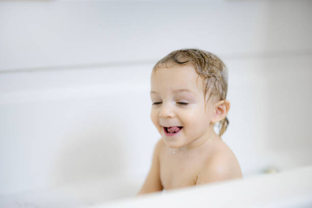 istock Happy Toddler Enjoying Bathtime with Joyful Expressions in a Bright Bathroom 2191204252