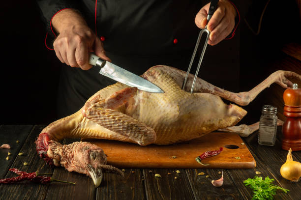 istock A chef prepares a raw turkey on the kitchen counter with spices and aromatic herbs. An idea for cooking a delicious bird in a cozy kitchen for a meat dinner 2191205405