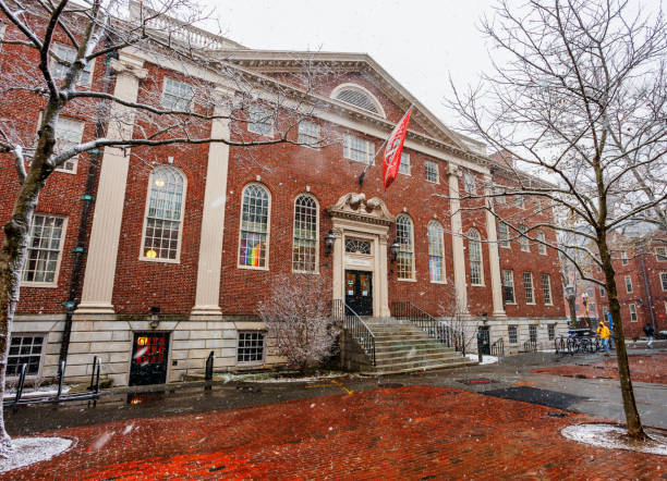Cambridge, Massachusetts, USA - December 20, 2024: Snow falling in front of Lehman Hall in Harvard University's Harvard Yard. Lehman Hall is a Georgian-revival building by Charles Coolidge completed in 1925. It is the student center of the Graduate School of Arts and Sciences (GSAS).