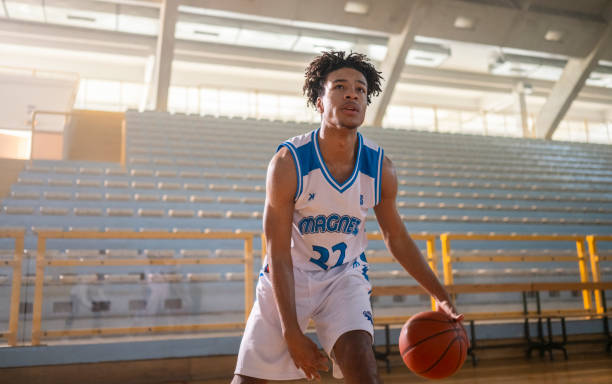 istock Basketball player dribbling ball at court 2191206098