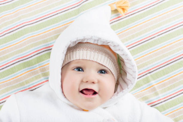 istock Little baby in winter hat on white bed 2191206562
