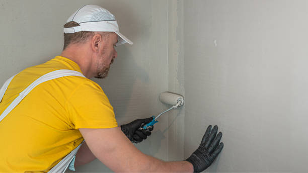 istock A worker applies a liquid membrane on the bathroom wall. Foolproof waterproofing under a tile bathroom. 2191206940