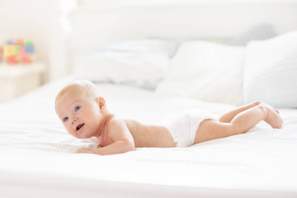 istock Little baby on white bed 2191206961