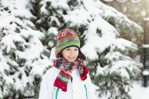 istock Kids play in snow in winter park 2191207342