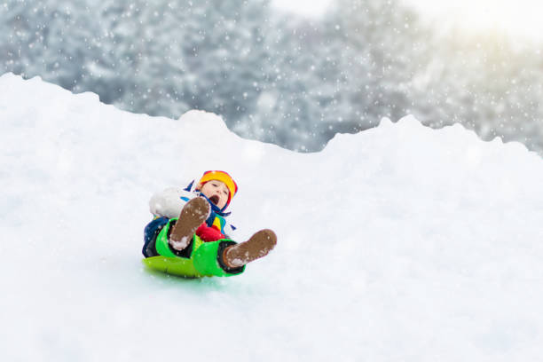 istock Girl on sled ride. Child sledding. Kid on sledge 2191207571