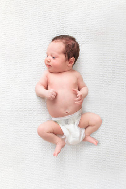 istock Little baby on white bed 2191207816