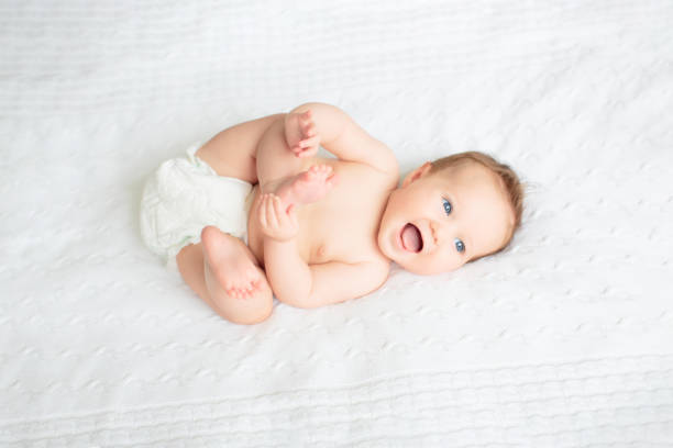 istock Little baby on white bed 2191208031