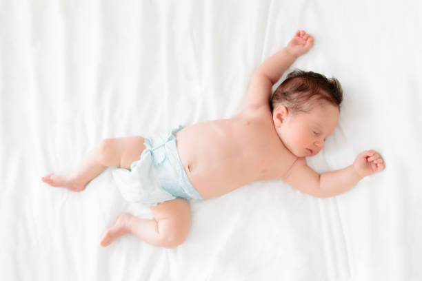 istock Little baby on white bed 2191208063