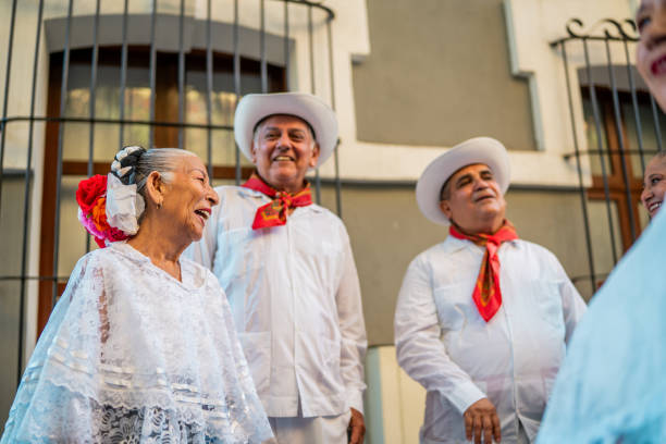 istock Senior traditional Mexican dancers talking outdoors 2191208149