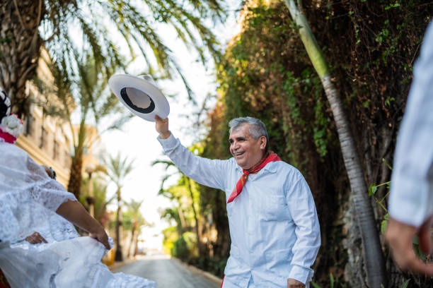 A red, white, and green hat is placed on top of a red, white, and green bowl. The hat is decorated with a red stripe and a white stripe. Decoration to celebrate Independence Day in Mexico, zocalo