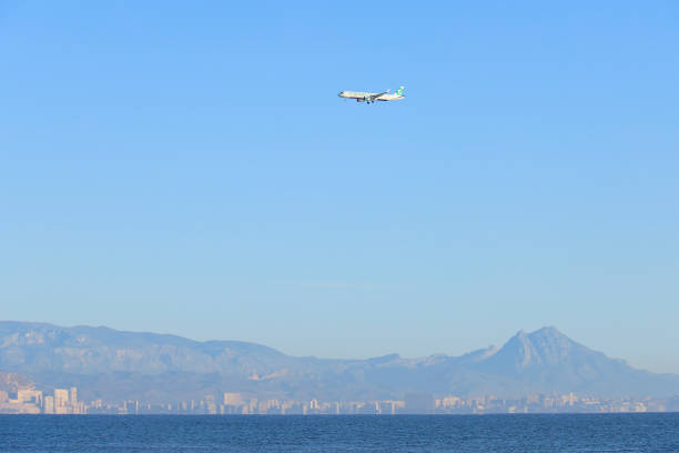 Alicante, Spain- November 28, 2024:Plane of TUI company flying over the coast and approaching airport with clearly sky in Alicante