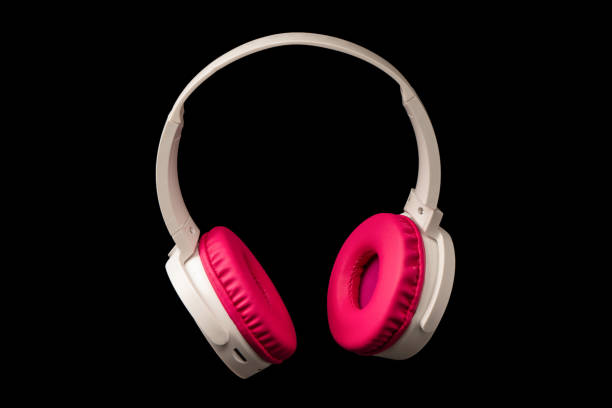 istock Pink and white headphones isolated on a black background. 2191210323