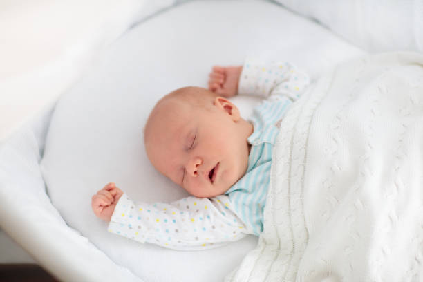 istock Cute newborn baby in white bed 2191210849